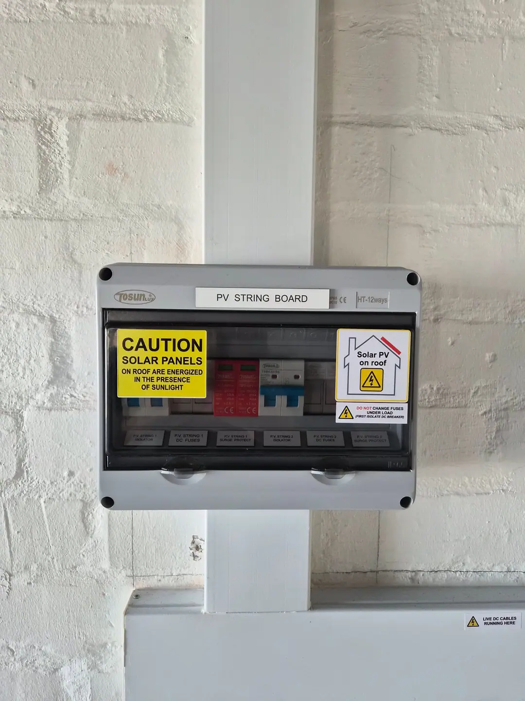 A labelled PV string board with DC isolators, fuses and surge protection