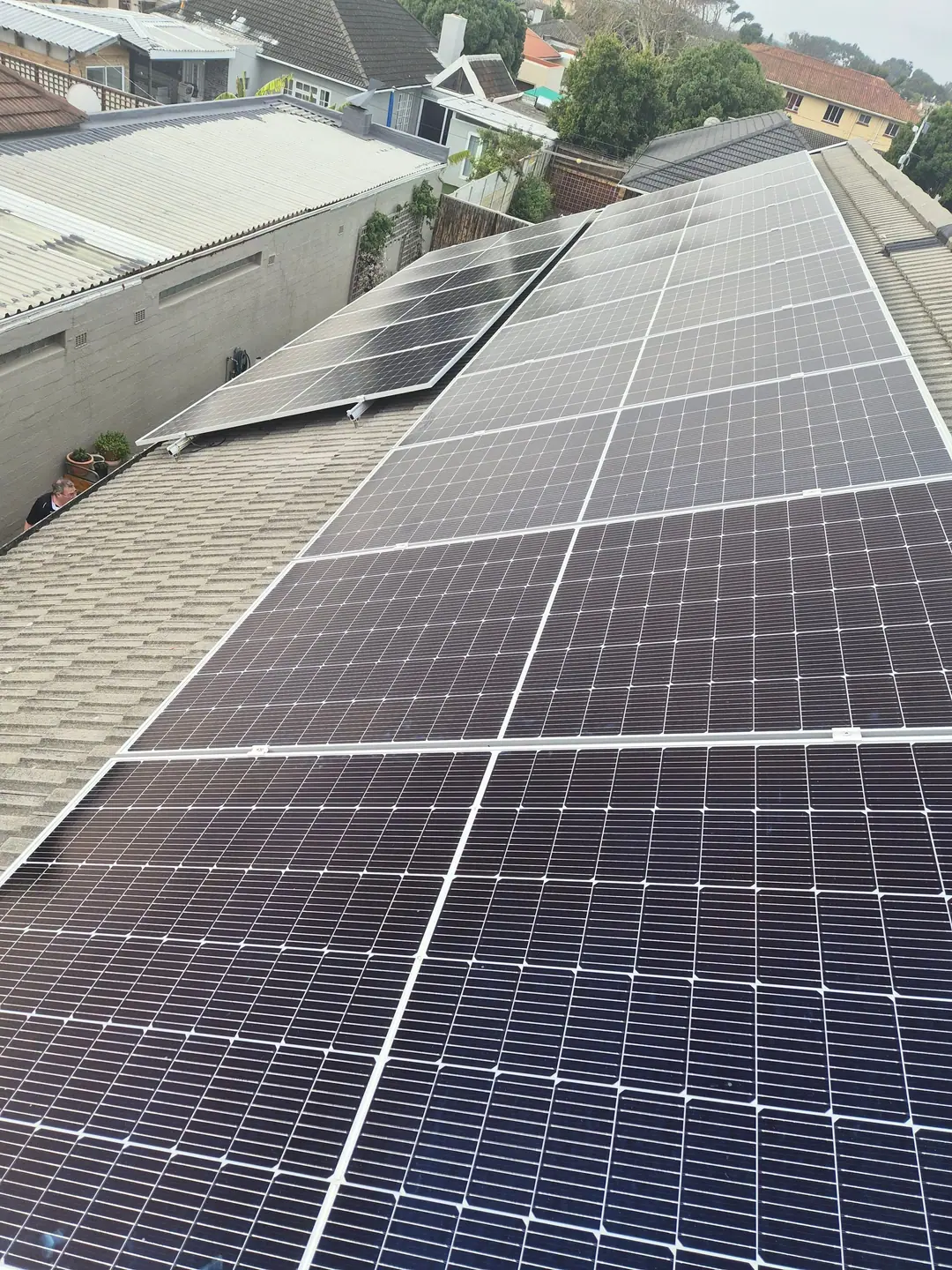 A finished rooftop solar array running the length of a tiled roof in Cape Town