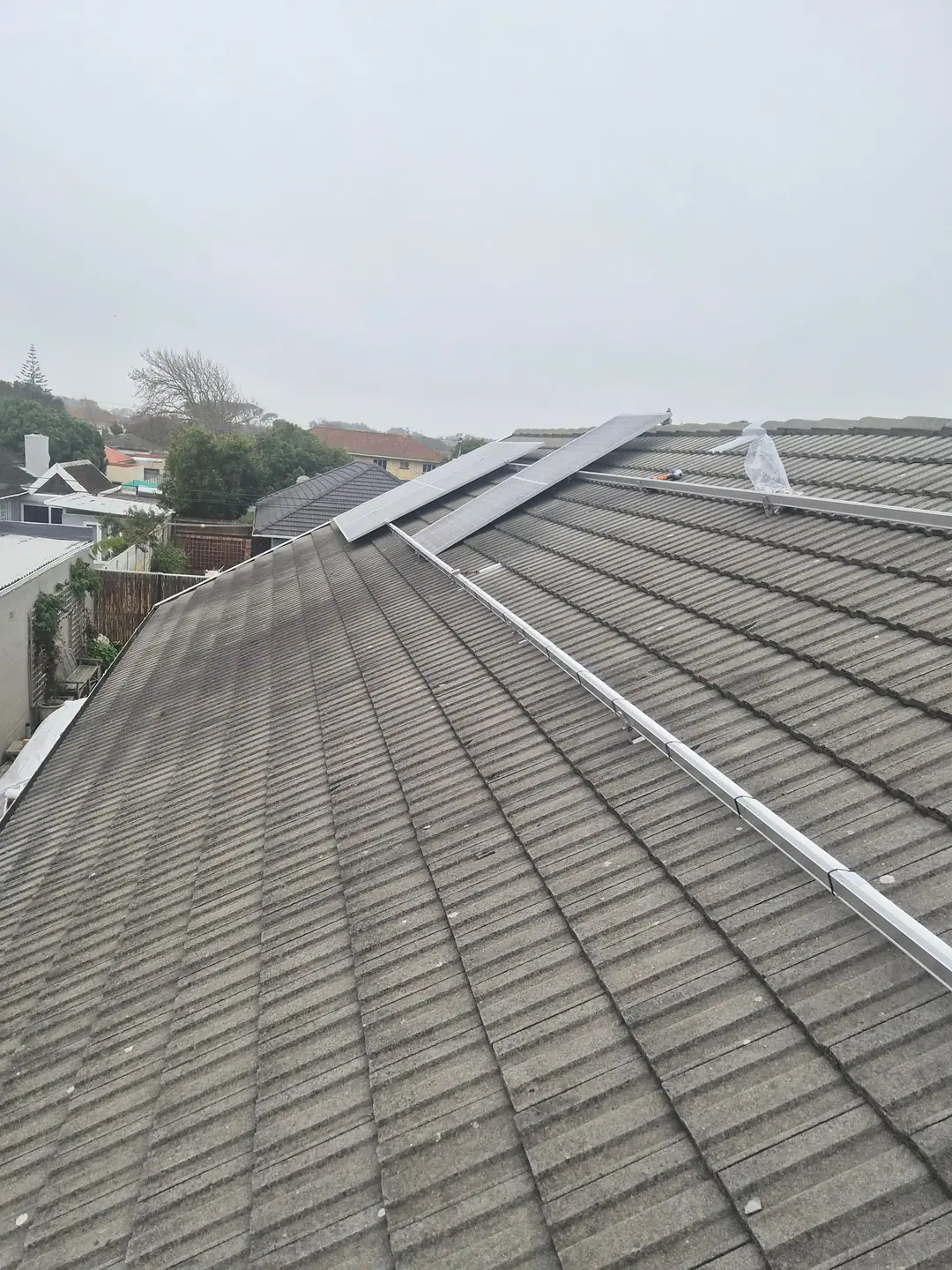 Mounting rails in place and the first panels going onto the roof