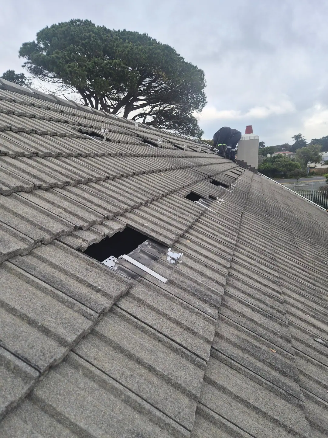 Solar roof hooks fitted under the tiles before the rails go on